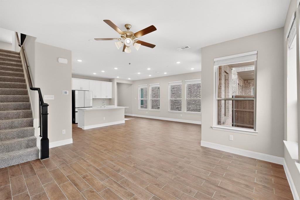 900 Heart Reef Road Plano, TX 75075 - Photo 7 of 40 a view of an empty room with wooden floor and a window