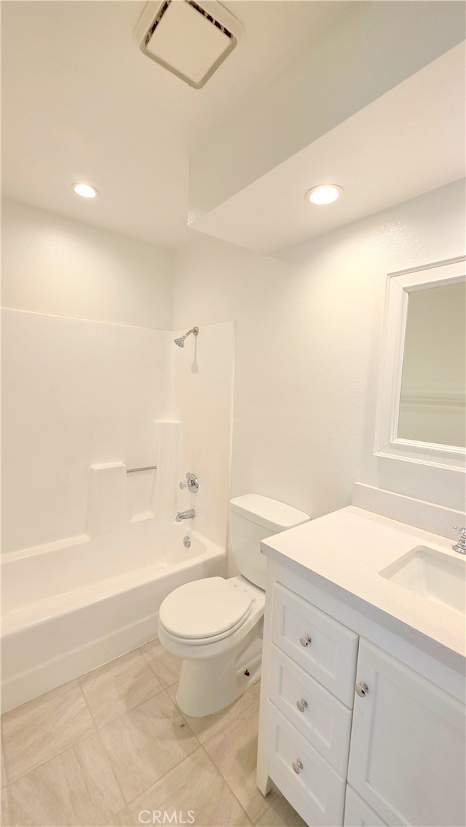 8708 1/2 Pine Crest Place Rancho Cucamonga, CA 91730 - Photo 14 of 22 a bathroom with a toilet a sink a mirror and a bathtub