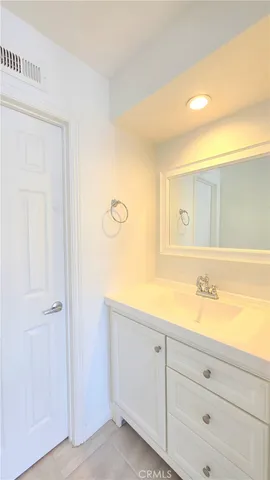 a bathroom with a sink a toilet and mirror