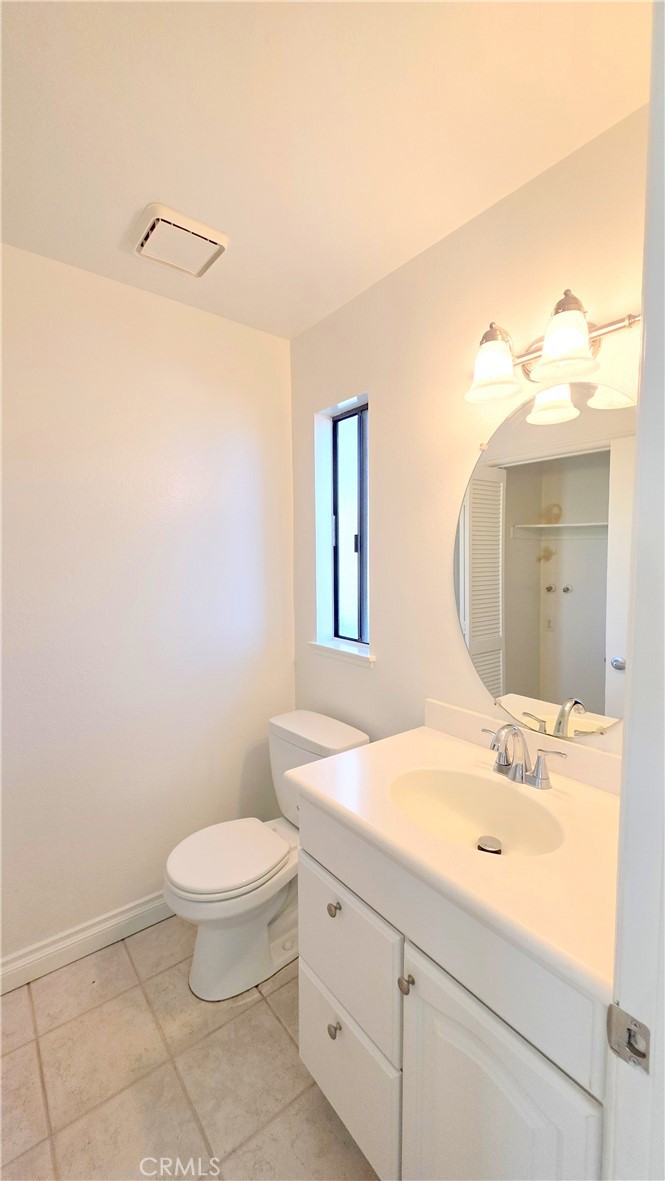 8708 1/2 Pine Crest Place Rancho Cucamonga, CA 91730 - Photo 16 of 22 a bathroom with a sink a toilet and mirror