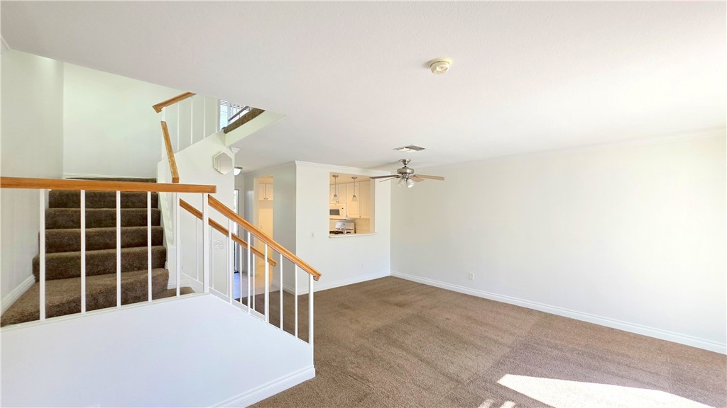 8708 1/2 Pine Crest Place Rancho Cucamonga, CA 91730 - Photo 4 of 22 a view of a hallway with wooden floor and windows
