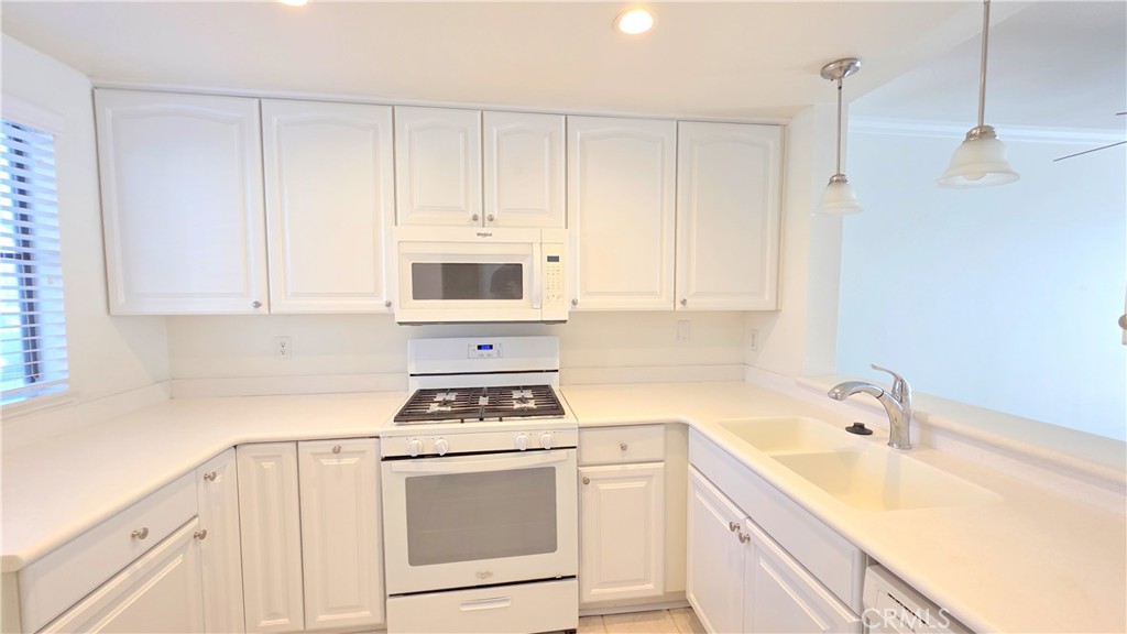 8708 1/2 Pine Crest Place Rancho Cucamonga, CA 91730 - Photo 6 of 22 a kitchen with white cabinets and white appliances