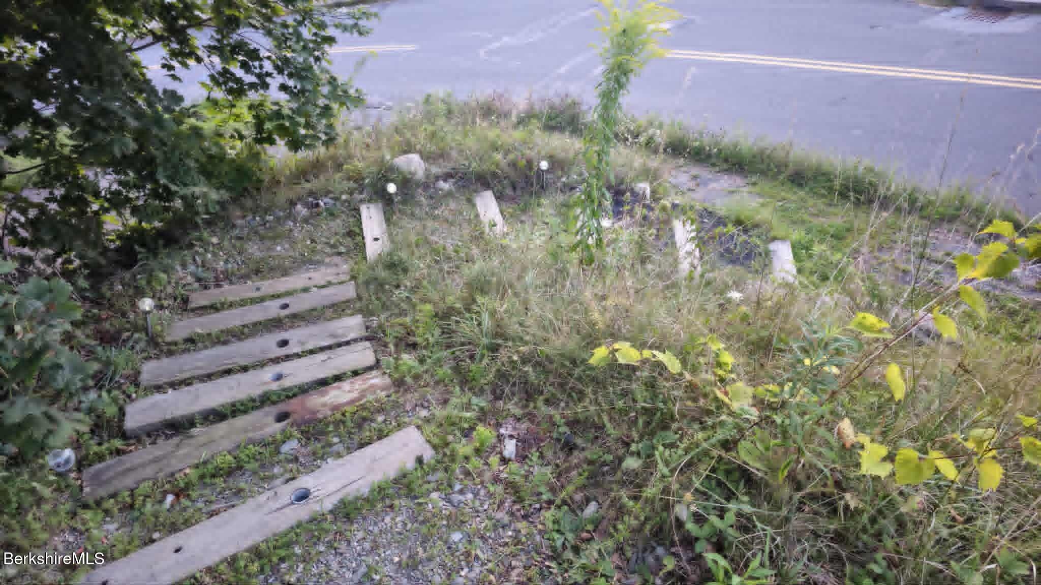 24 Franklin Street North Adams, MA 01247 - Photo 17 of 45 a view of a yard with plants and a bench