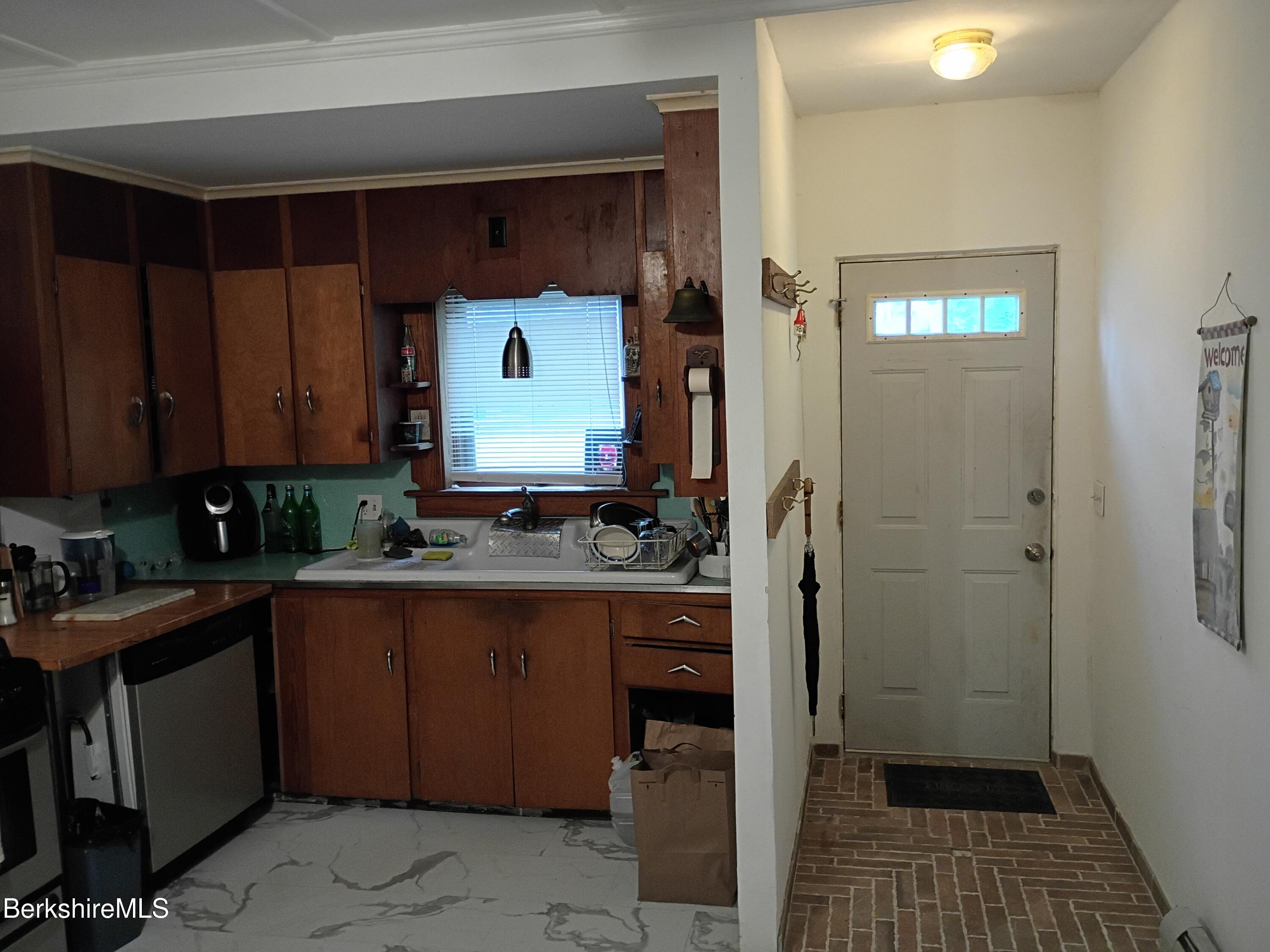 24 Franklin Street North Adams, MA 01247 - Photo 20 of 45 a kitchen with a sink a refrigerator and cabinets