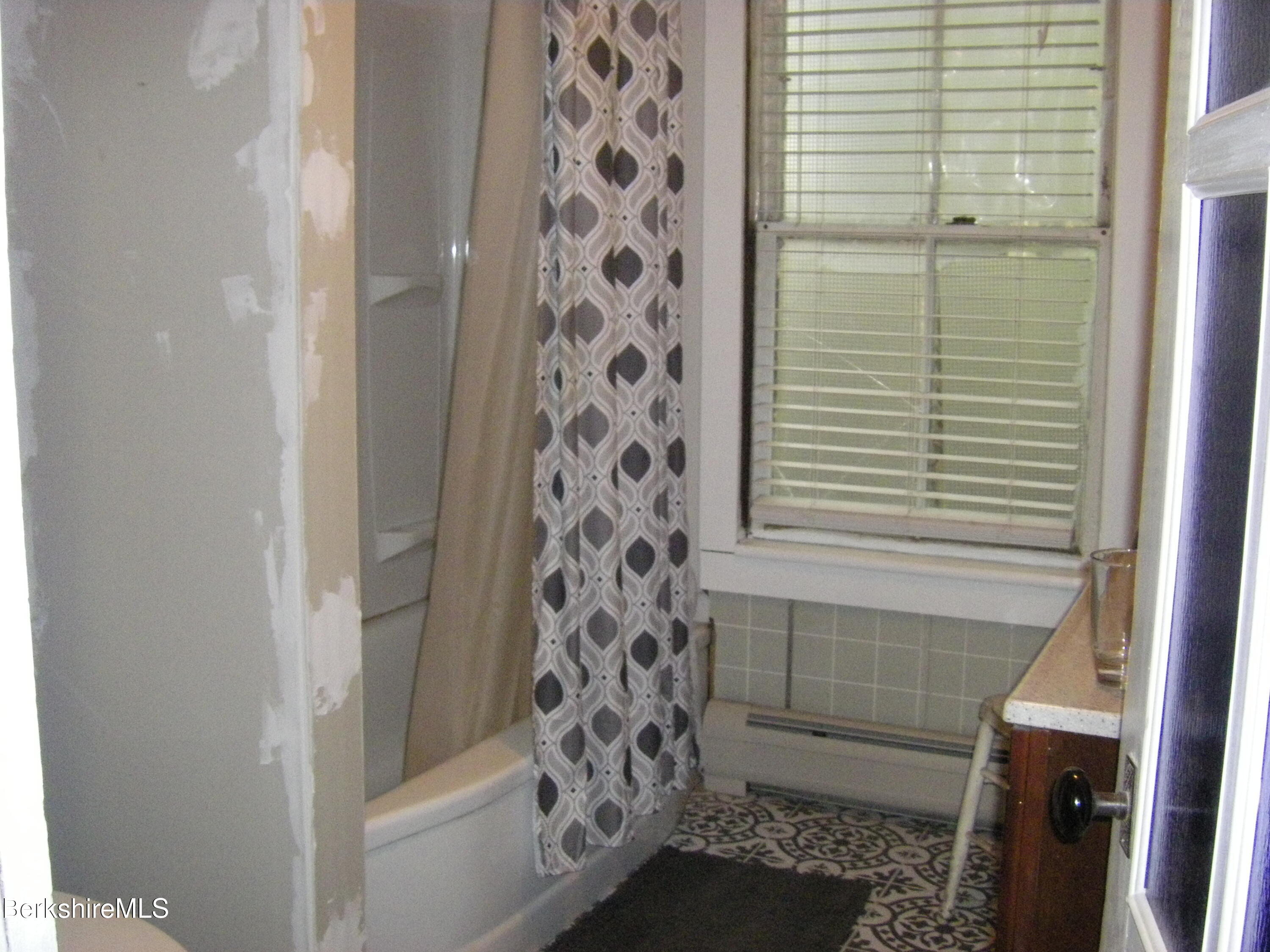 24 Franklin Street North Adams, MA 01247 - Photo 31 of 43 a bathroom with a bathtub and shower