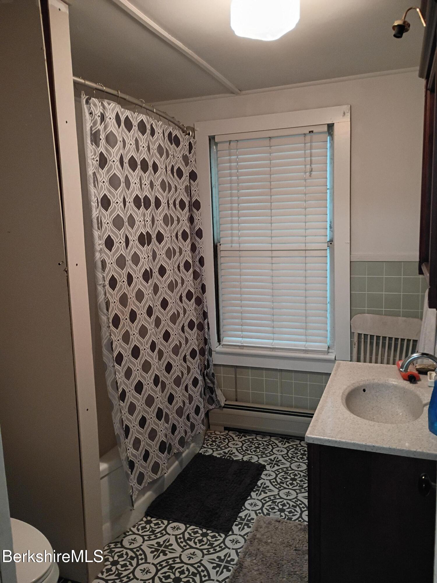 24 Franklin Street North Adams, MA 01247 - Photo 34 of 45 a bathroom with a sink a toilet a window and vanity