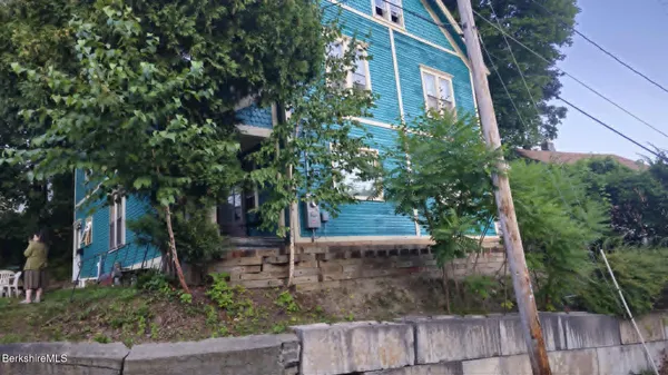 a view of a house with a tree