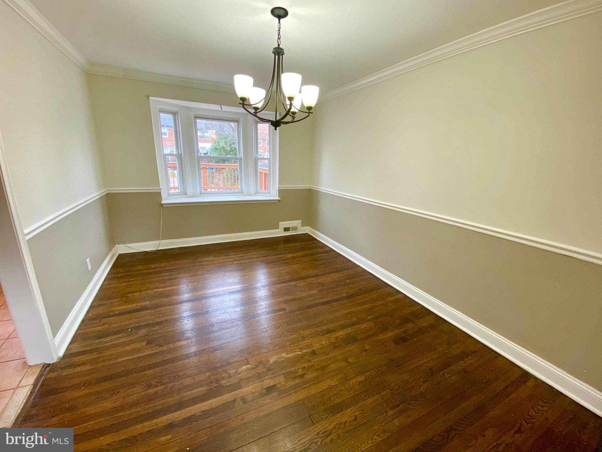 1604 Pentwood Road Baltimore, MD 21239 - Photo 12 of 19 a view of room with window and wooden floor