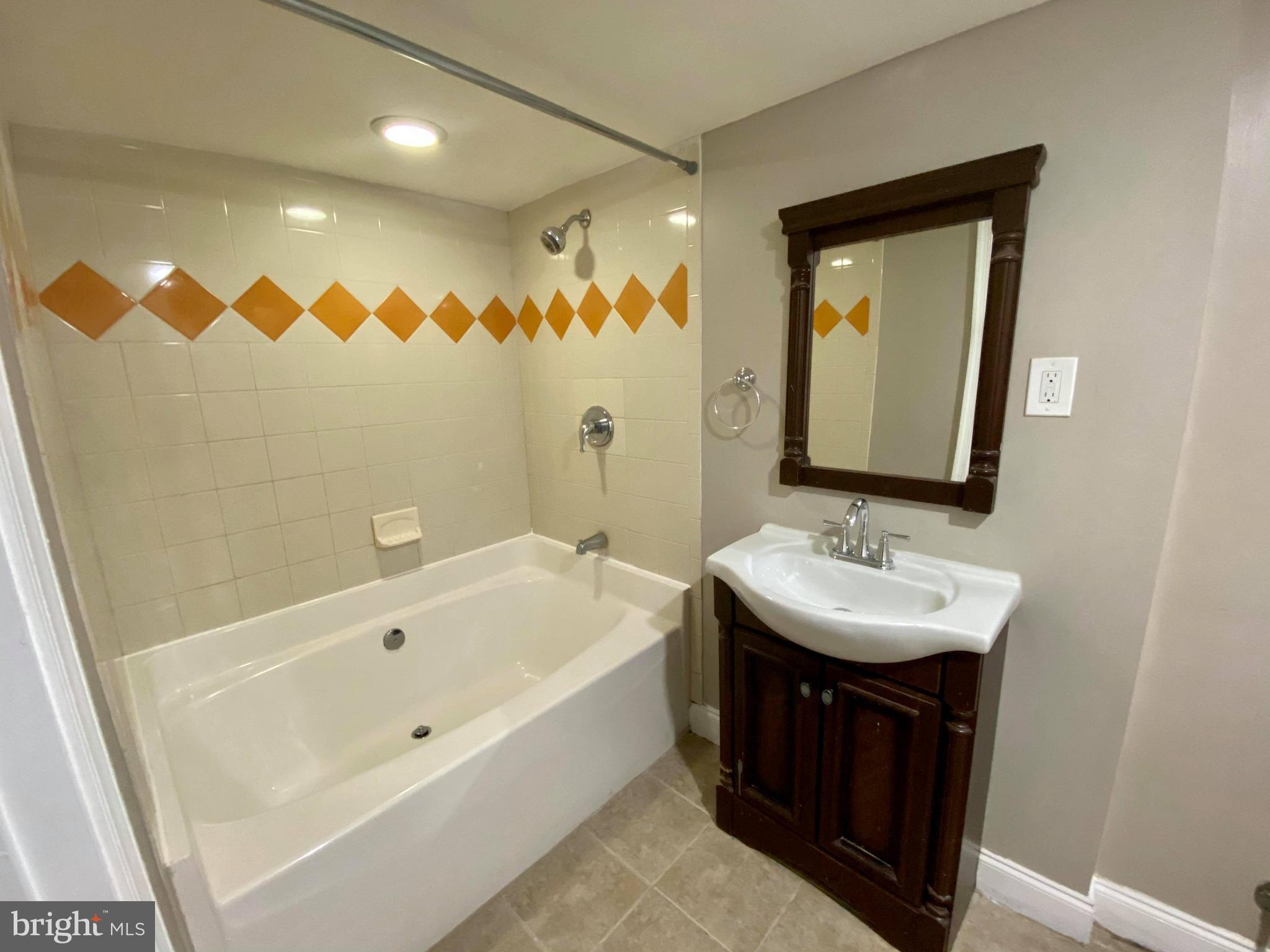 1604 Pentwood Road Baltimore, MD 21239 - Photo 14 of 19 a bathroom with a sink and a bathtub