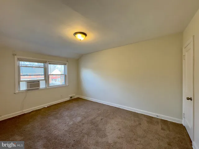 an empty room with a empty space and windows