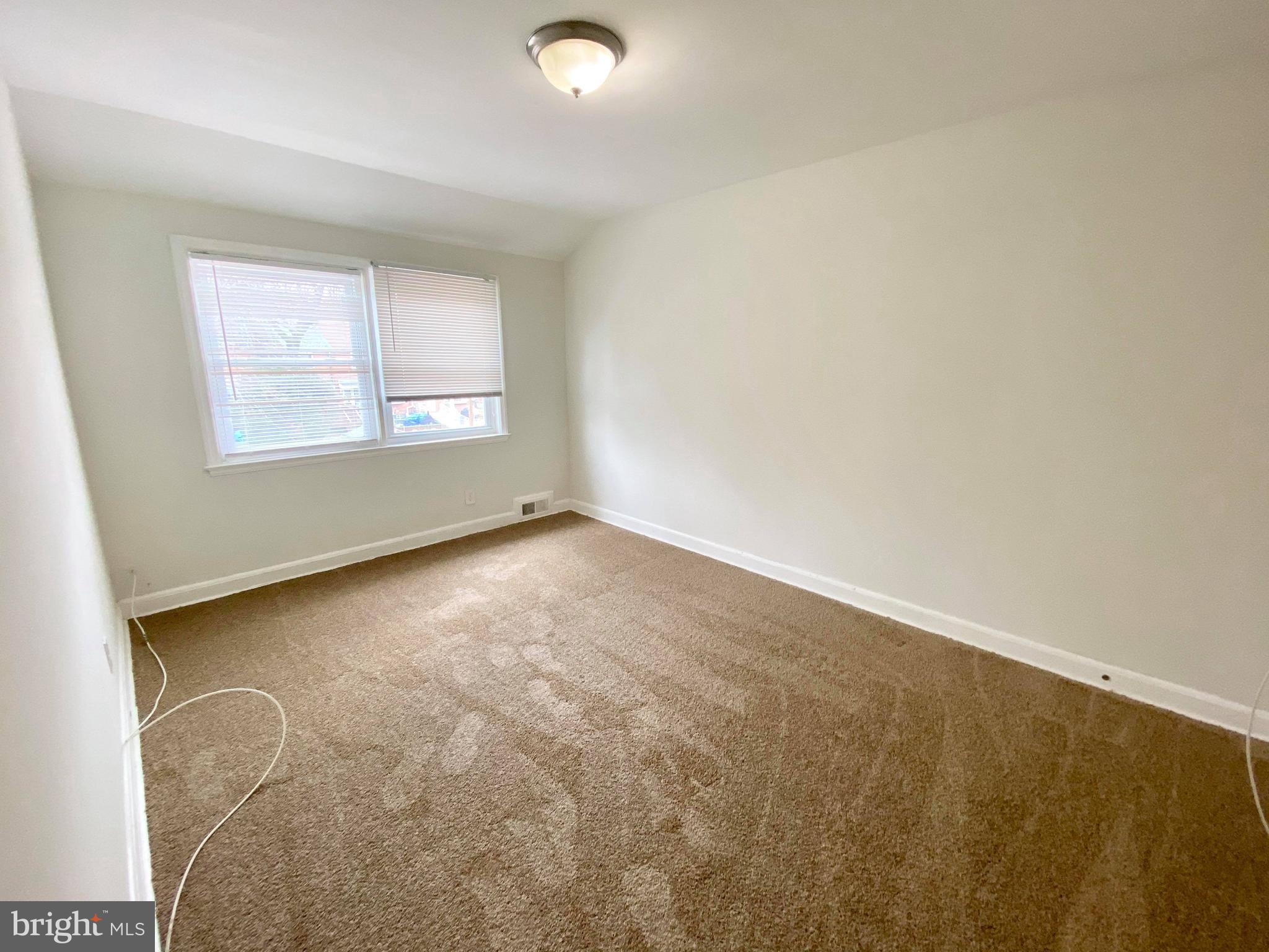1604 Pentwood Road Baltimore, MD 21239 - Photo 2 of 19 an empty room with a window
