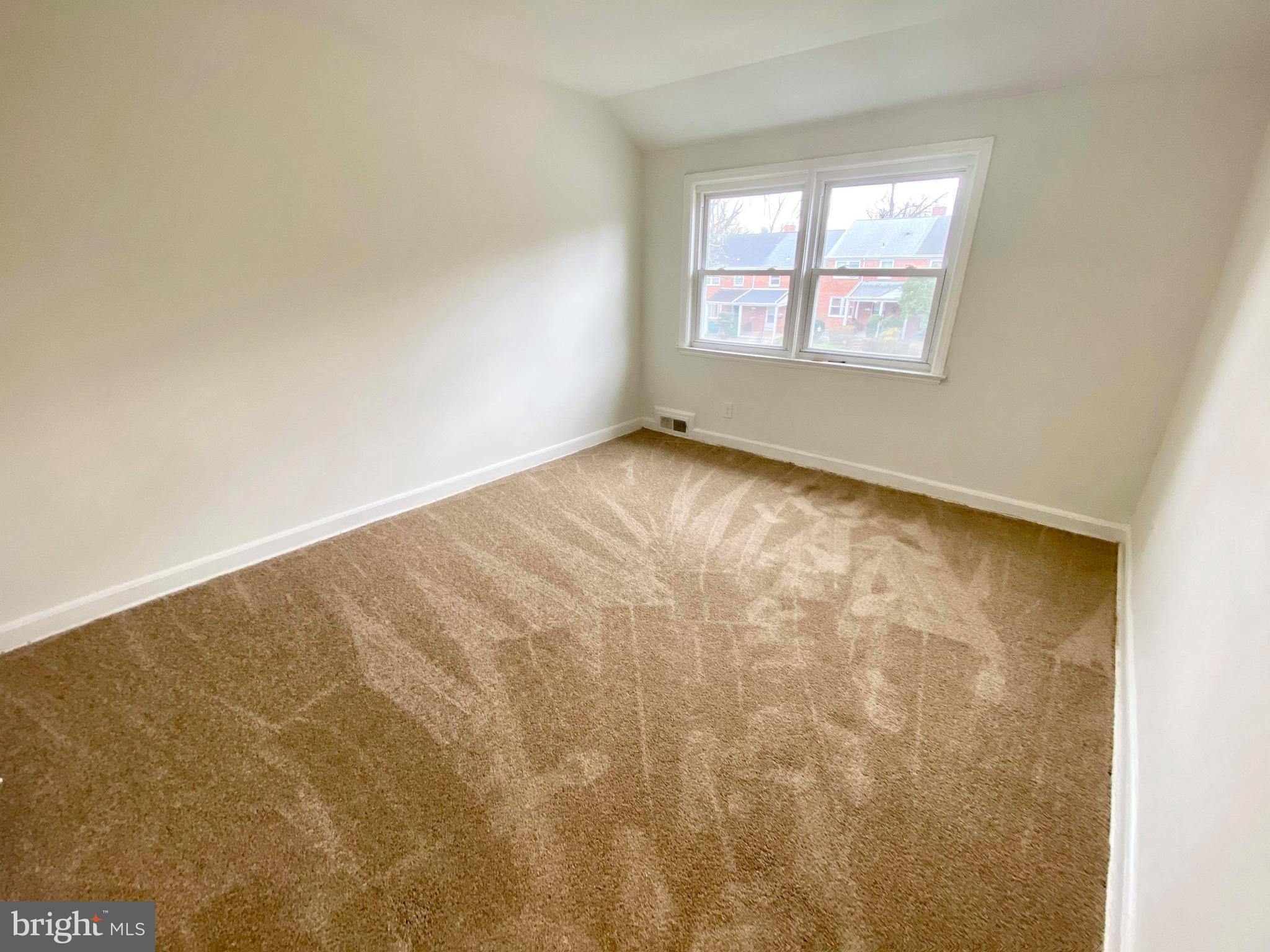 1604 Pentwood Road Baltimore, MD 21239 - Photo 3 of 19 an empty room with a windows