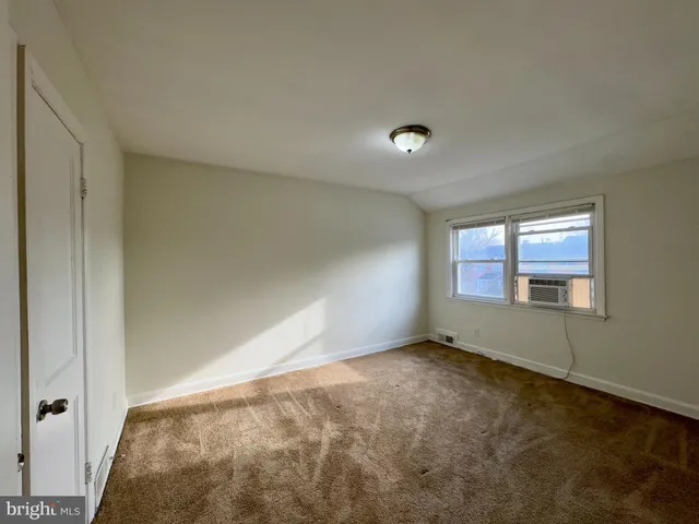 an empty room with a empty space and windows