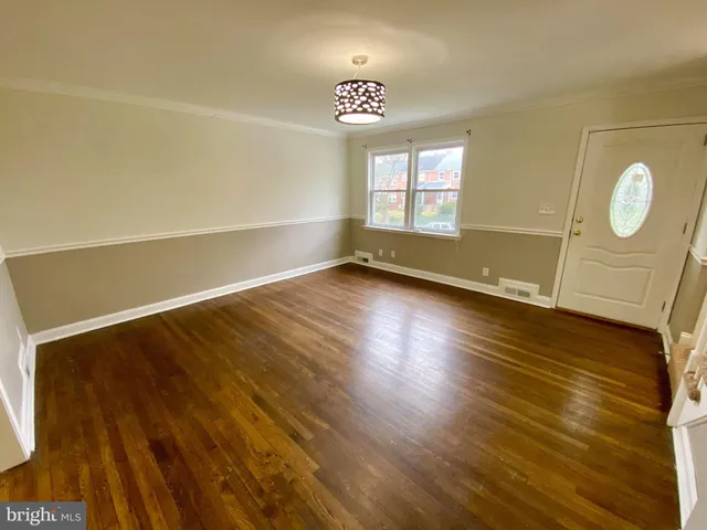 a view of room with window and wooden floor