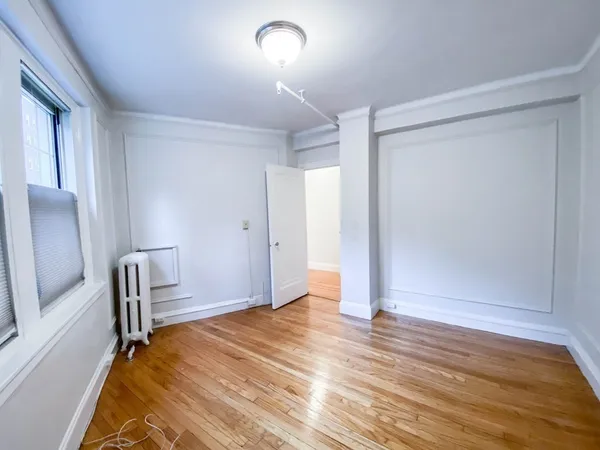 a view of room with window and wooden floor