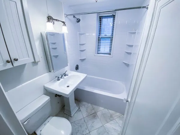 a bathroom with a sink toilet tub and shower