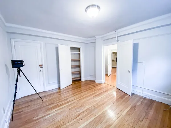 a view of an empty room with wooden floor