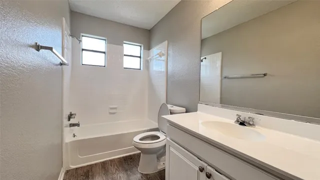a bathroom with a sink a toilet and a bathtub