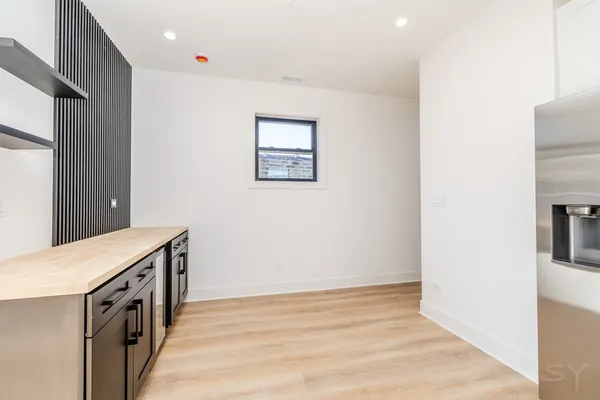 a kitchen with granite countertop a stove and a refrigerator