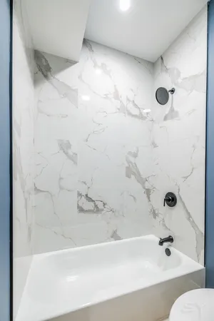 a bathroom with a bathtub and shower