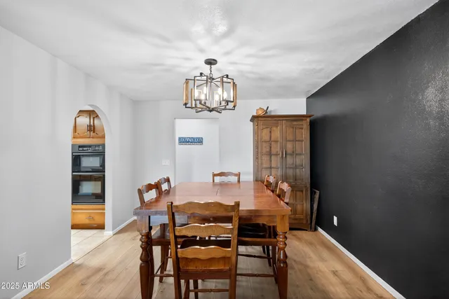 a view of a dining room with furniture and chandelier