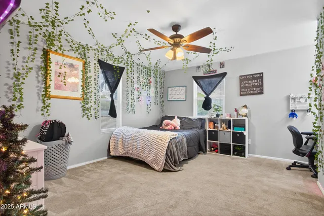 a bedroom with a bed couch and a window