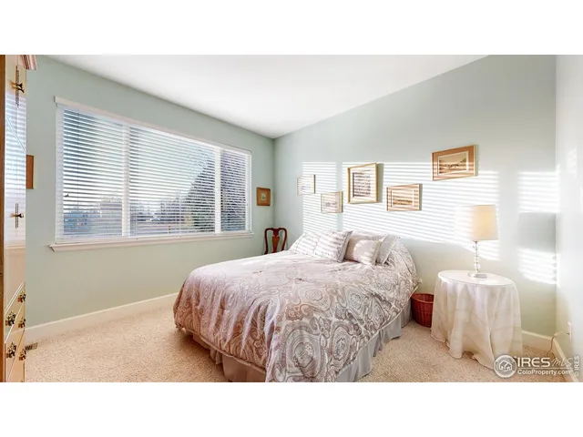 a living room with a bed furniture and a window