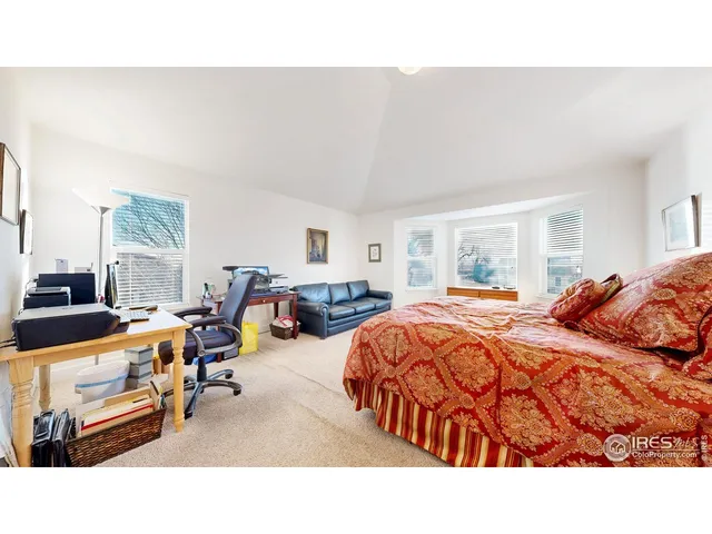 a living room with a bed and chair