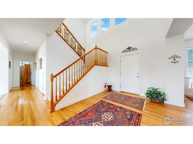 a living room with a couch and kitchen view