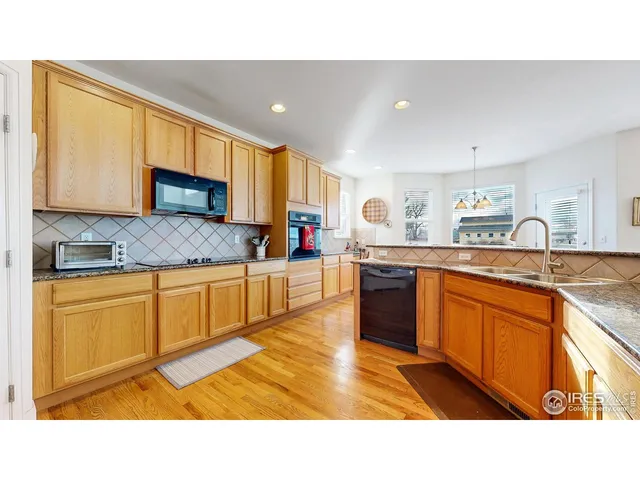 a kitchen with a sink and a stove top oven