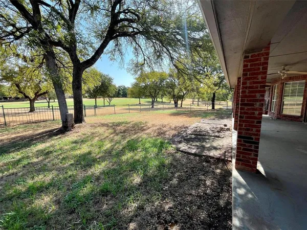 a view of dirt yard with a trees