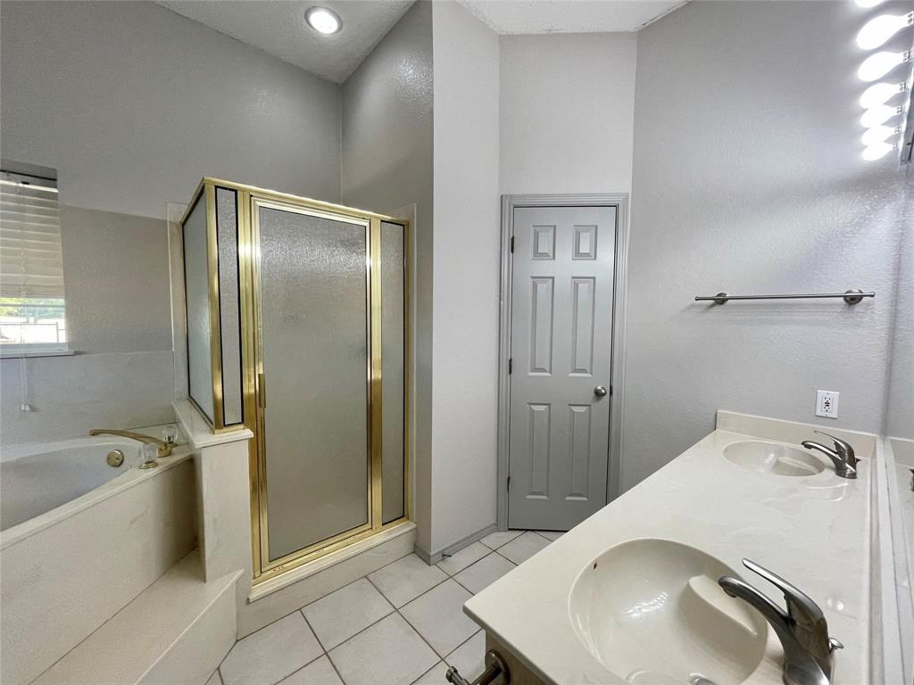 8701 Bellechase Road Granbury, TX 76049 - Photo 6 of 15 a bathroom with a sink a toilet and shower