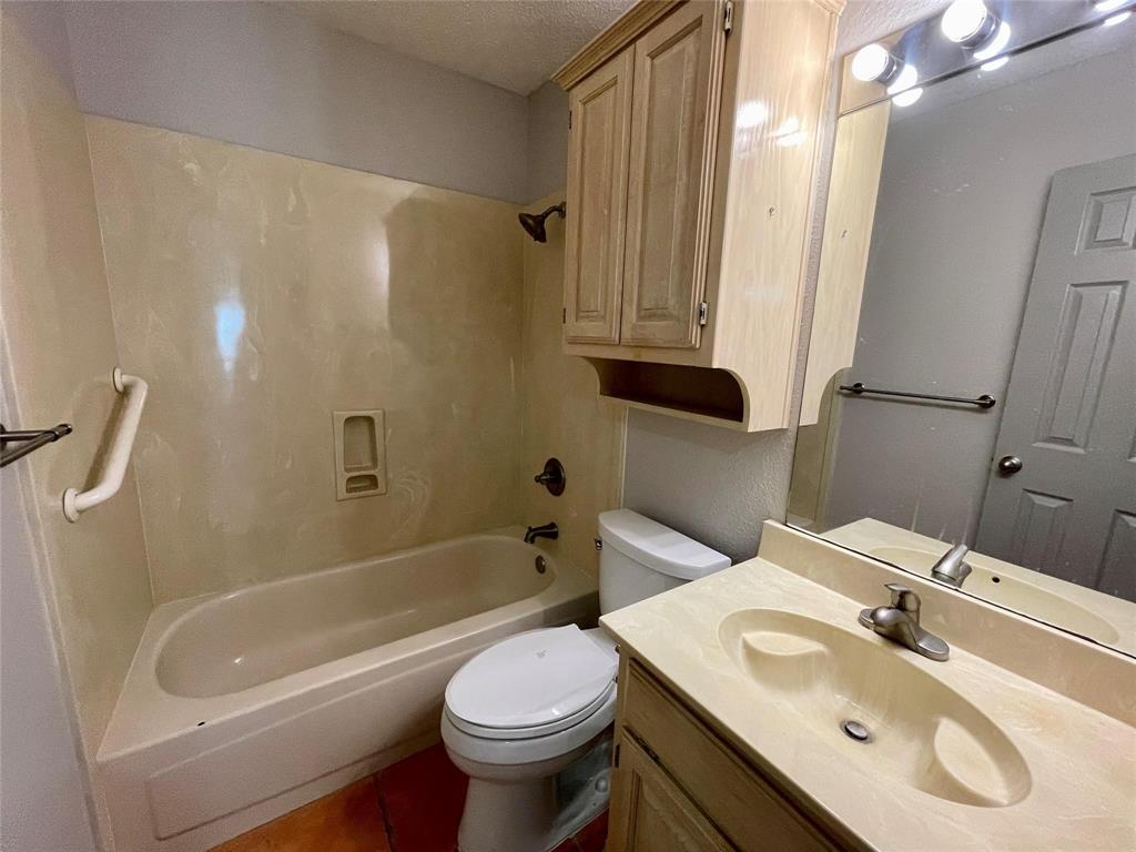 8701 Bellechase Road Granbury, TX 76049 - Photo 8 of 15 a bathroom with a sink a toilet and a bathtub