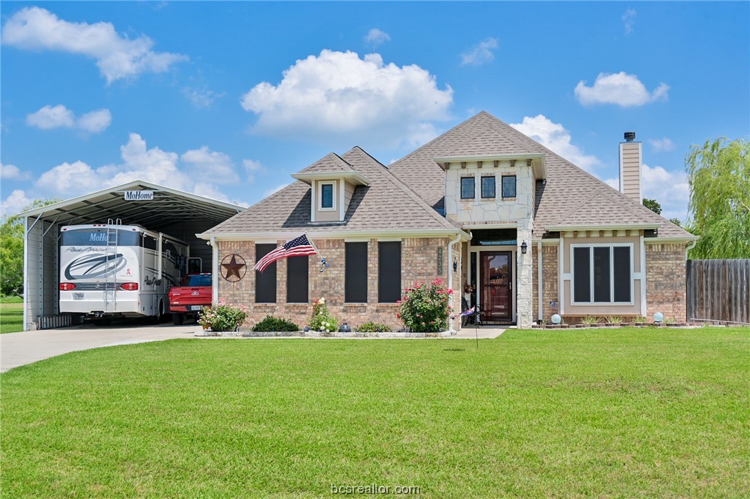 a front view of a house with a yard and porch