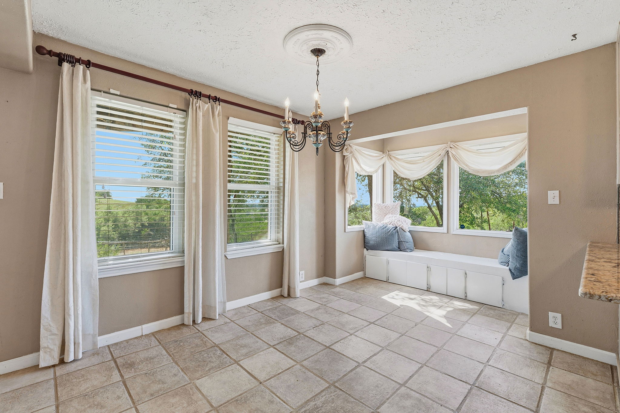 3230 West Fitzhugh Road Dripping Springs, TX 78620 - Photo 14 of 34 A charming breakfast nook with abundant windows captures pleasant outdoor views, perfect for morning meals.