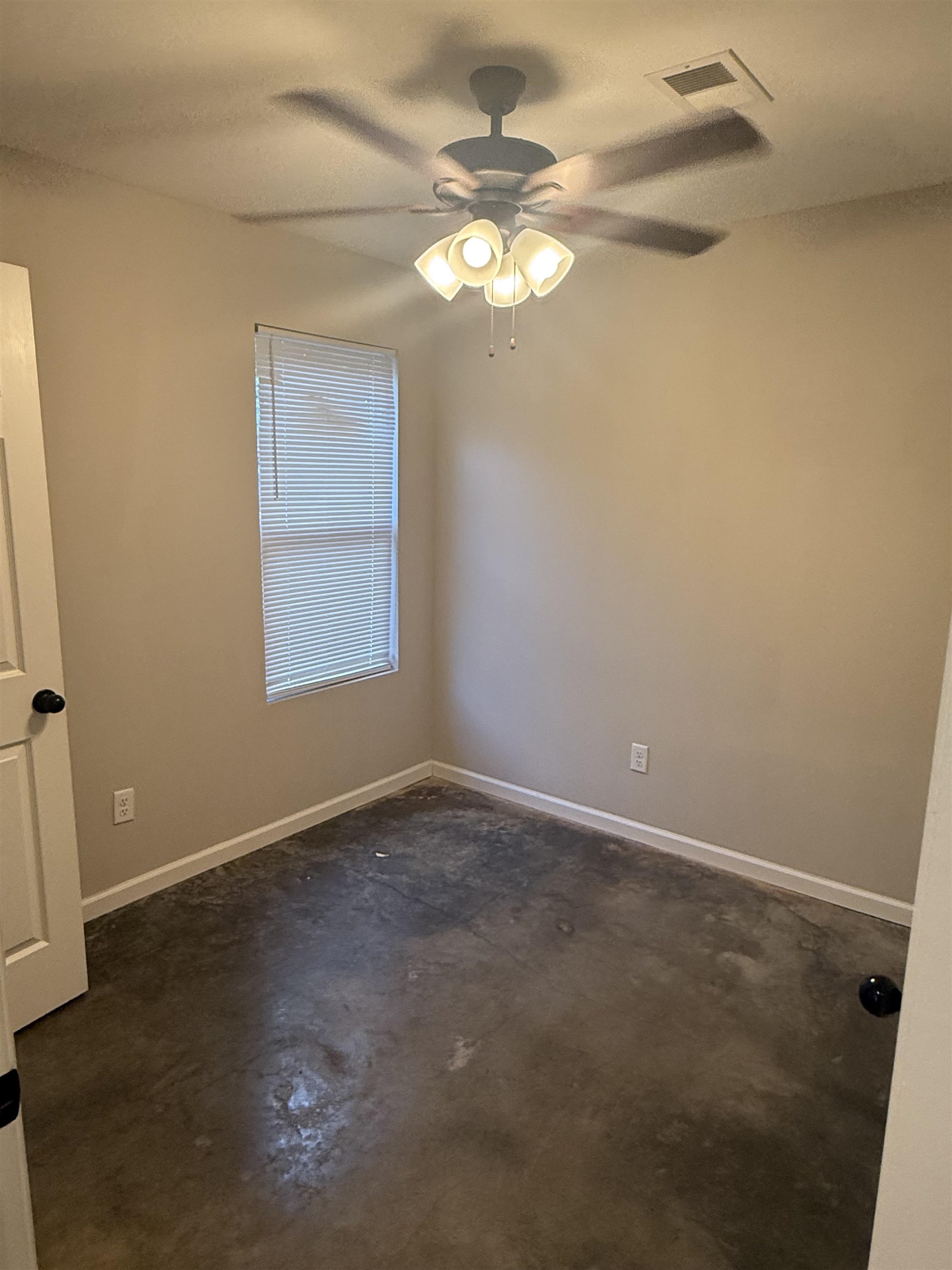 4589 Range Line Road Memphis, TN 38127 - Photo 14 of 25 an empty room with a chandelier fan and windows