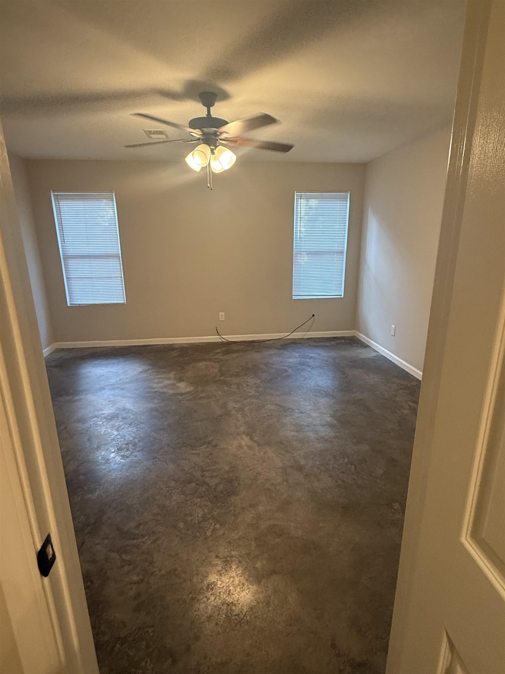 4589 Range Line Road Memphis, TN 38127 - Photo 24 of 25 en empty room with wooden floor and fan