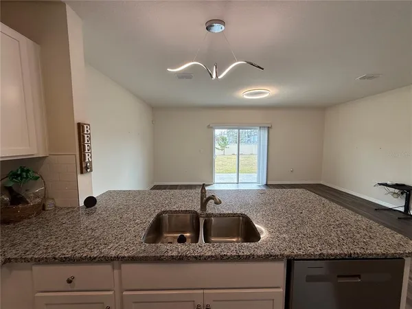 a kitchen with granite countertop a sink and a window