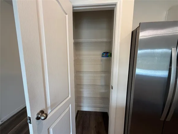a bathroom with a walk in closet and mirror
