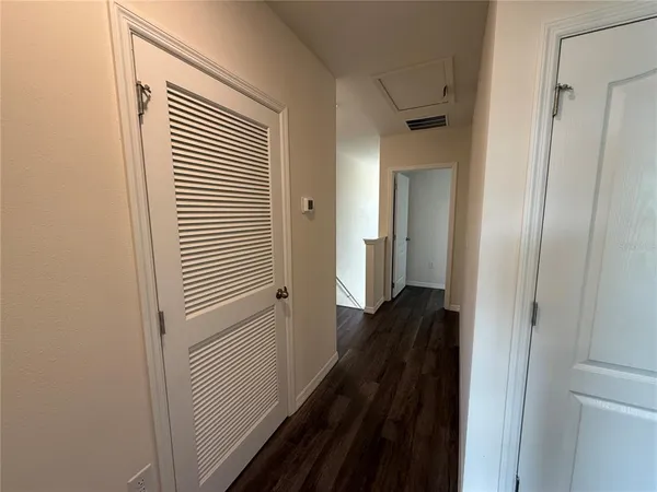 a view of a hallway with a wooden floor