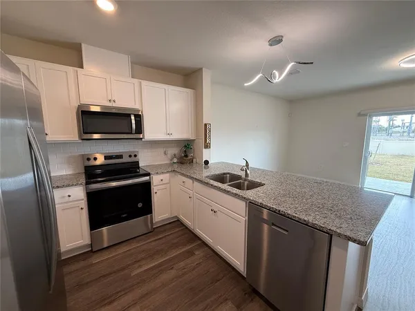 a kitchen with a sink stove and refrigerator