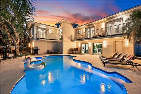 an aerial view of a house with a swimming pool