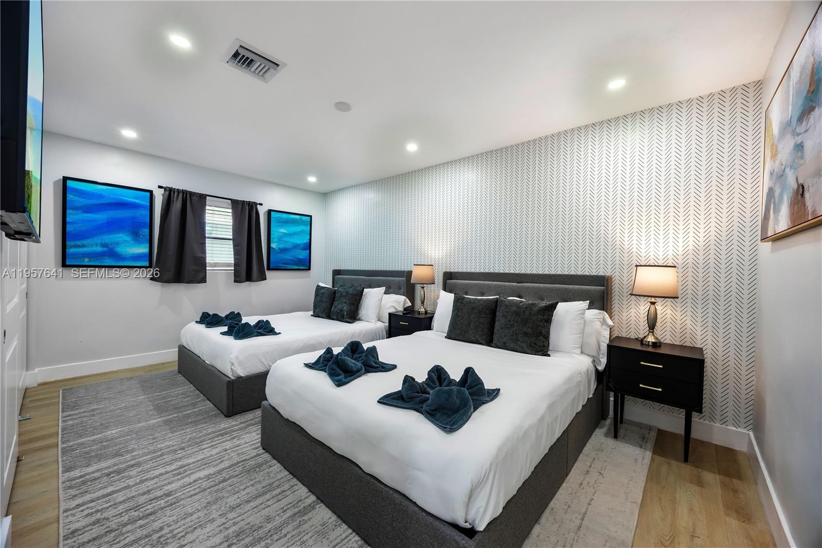 2532 Southeast 13th Street Pompano Beach, FL 33062 - Photo 28 of 69 a living room with couches and kitchen view with wooden floor