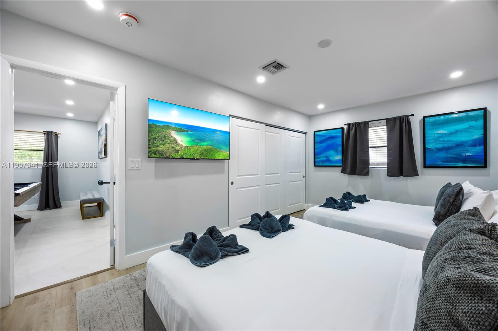 2532 Southeast 13th Street Pompano Beach, FL 33062 - Photo 29 of 69 a bedroom with a bed and a flat screen tv