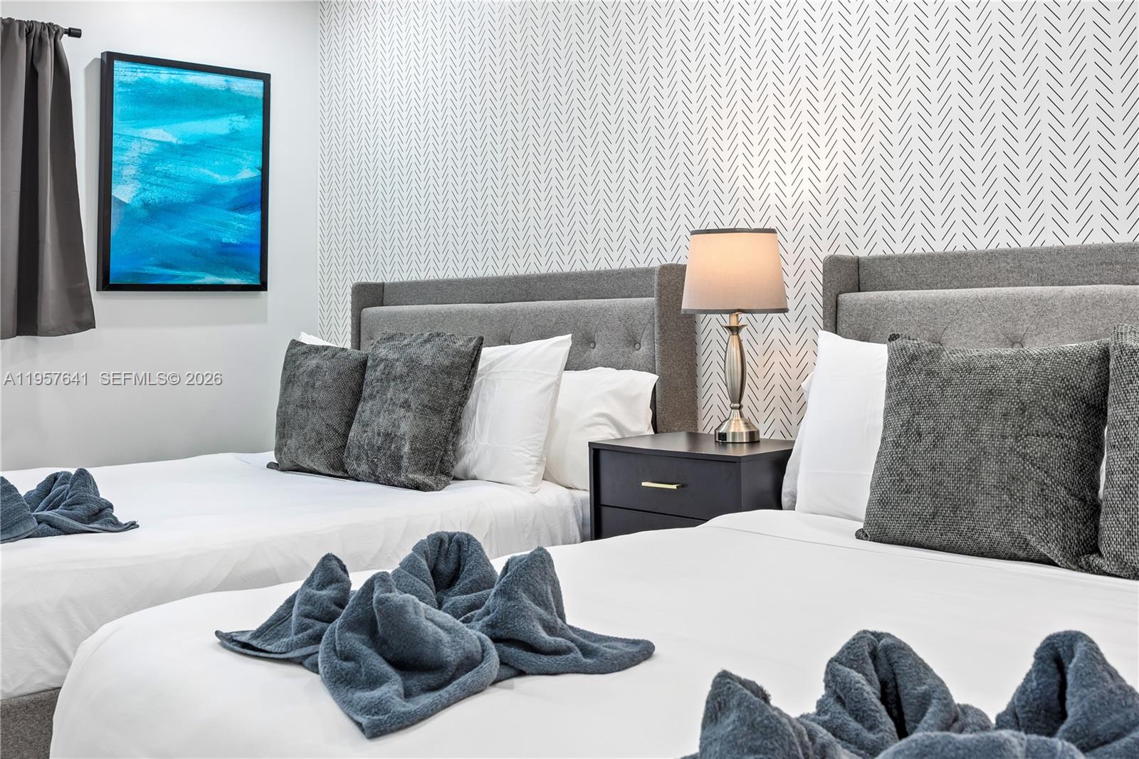 2532 Southeast 13th Street Pompano Beach, FL 33062 - Photo 31 of 69 a bedroom with a bed and wall painting