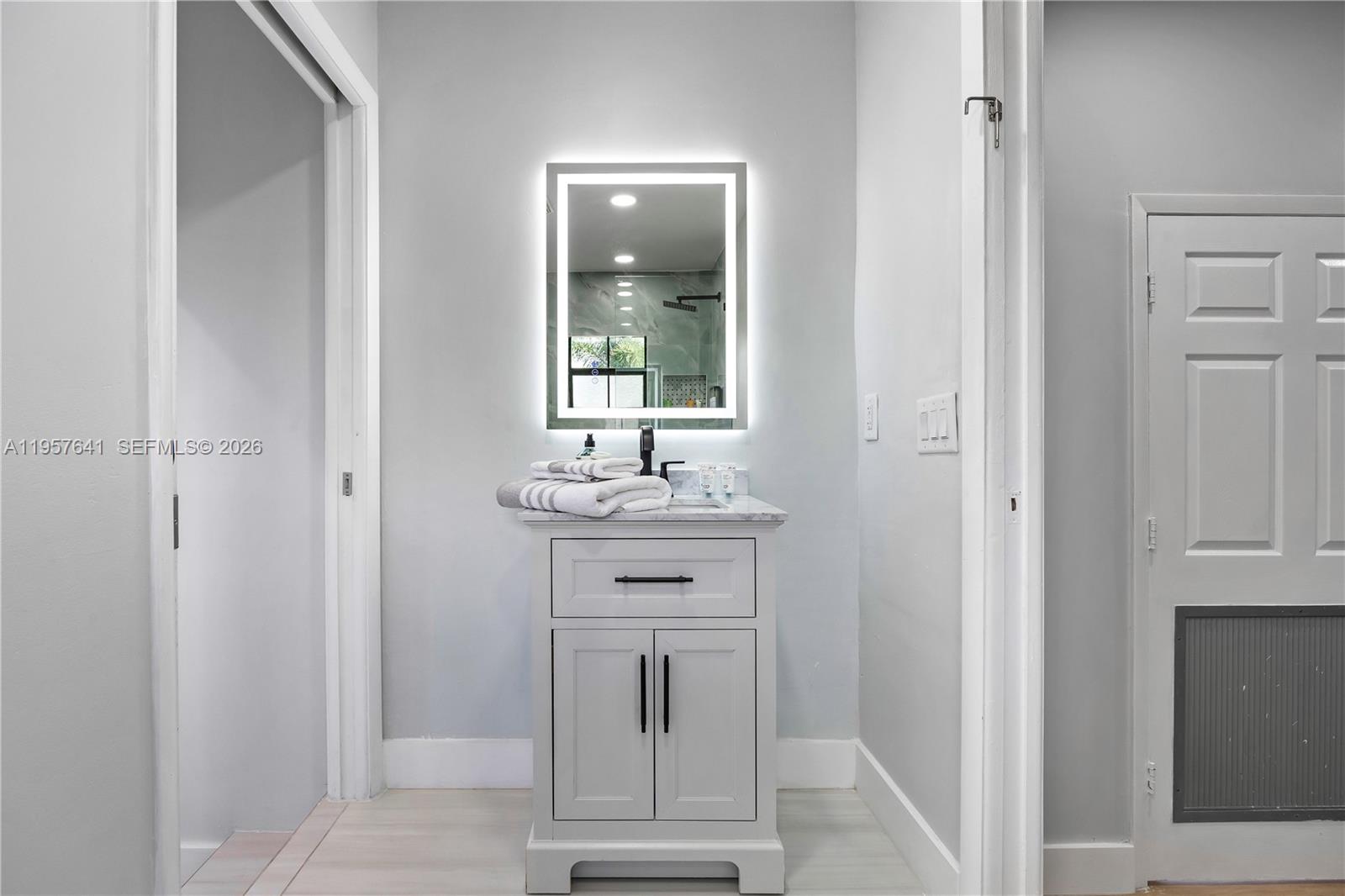 2532 Southeast 13th Street Pompano Beach, FL 33062 - Photo 40 of 69 a bathroom with a sink a toilet and mirror