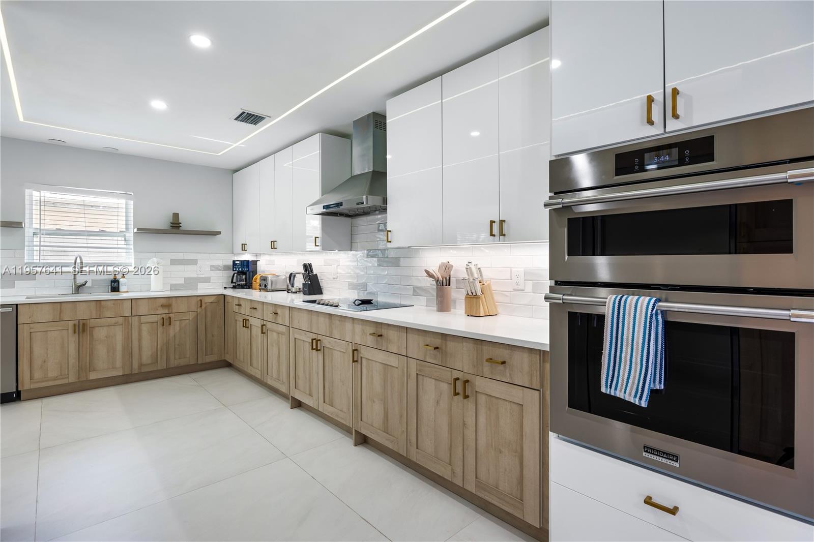 2532 Southeast 13th Street Pompano Beach, FL 33062 - Photo 42 of 69 a kitchen with stainless steel appliances kitchen island granite countertop a sink dishwasher stove and cabinets