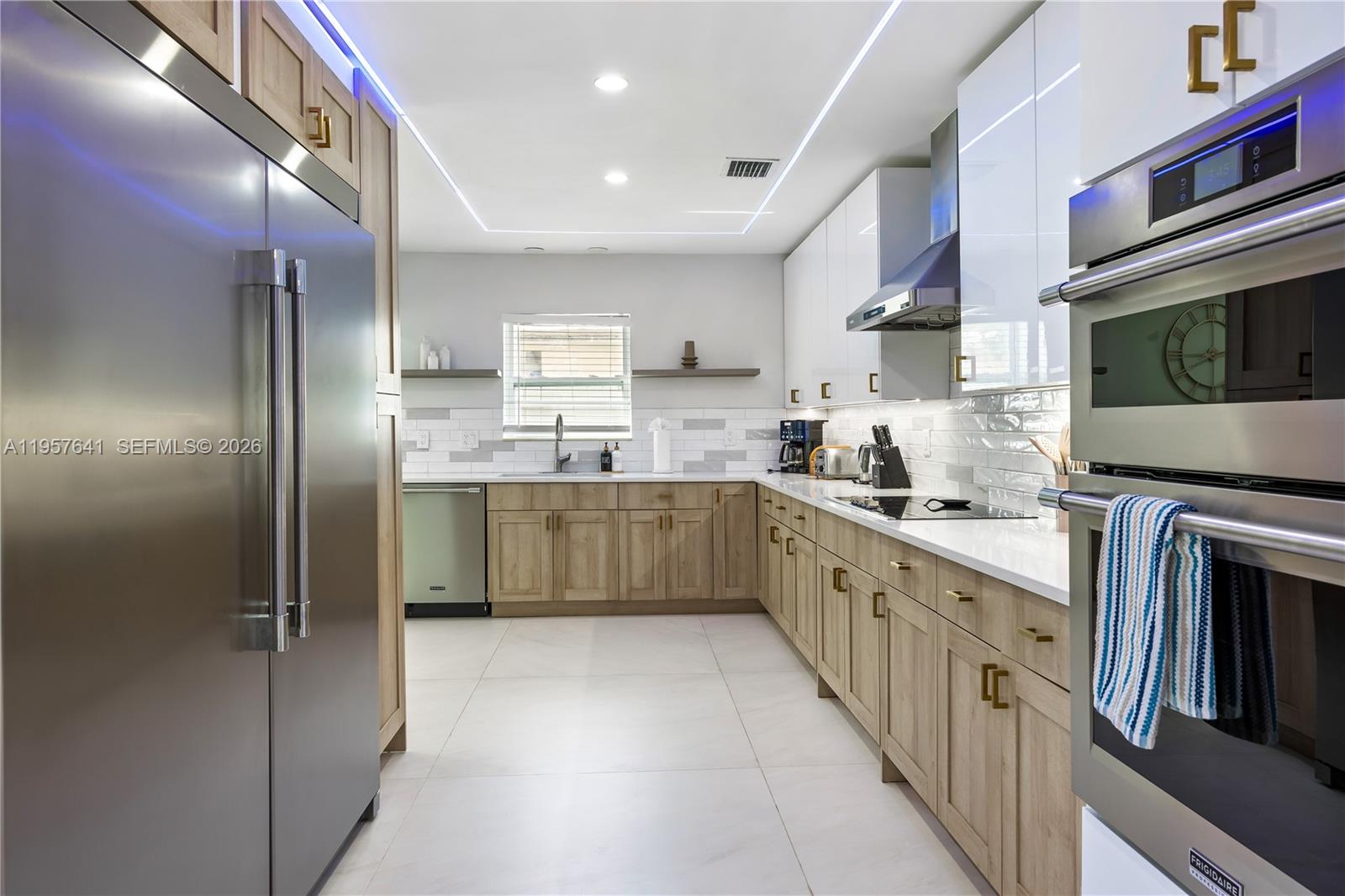 2532 Southeast 13th Street Pompano Beach, FL 33062 - Photo 43 of 69 a kitchen with stainless steel appliances granite countertop a sink a stove a refrigerator and cabinets