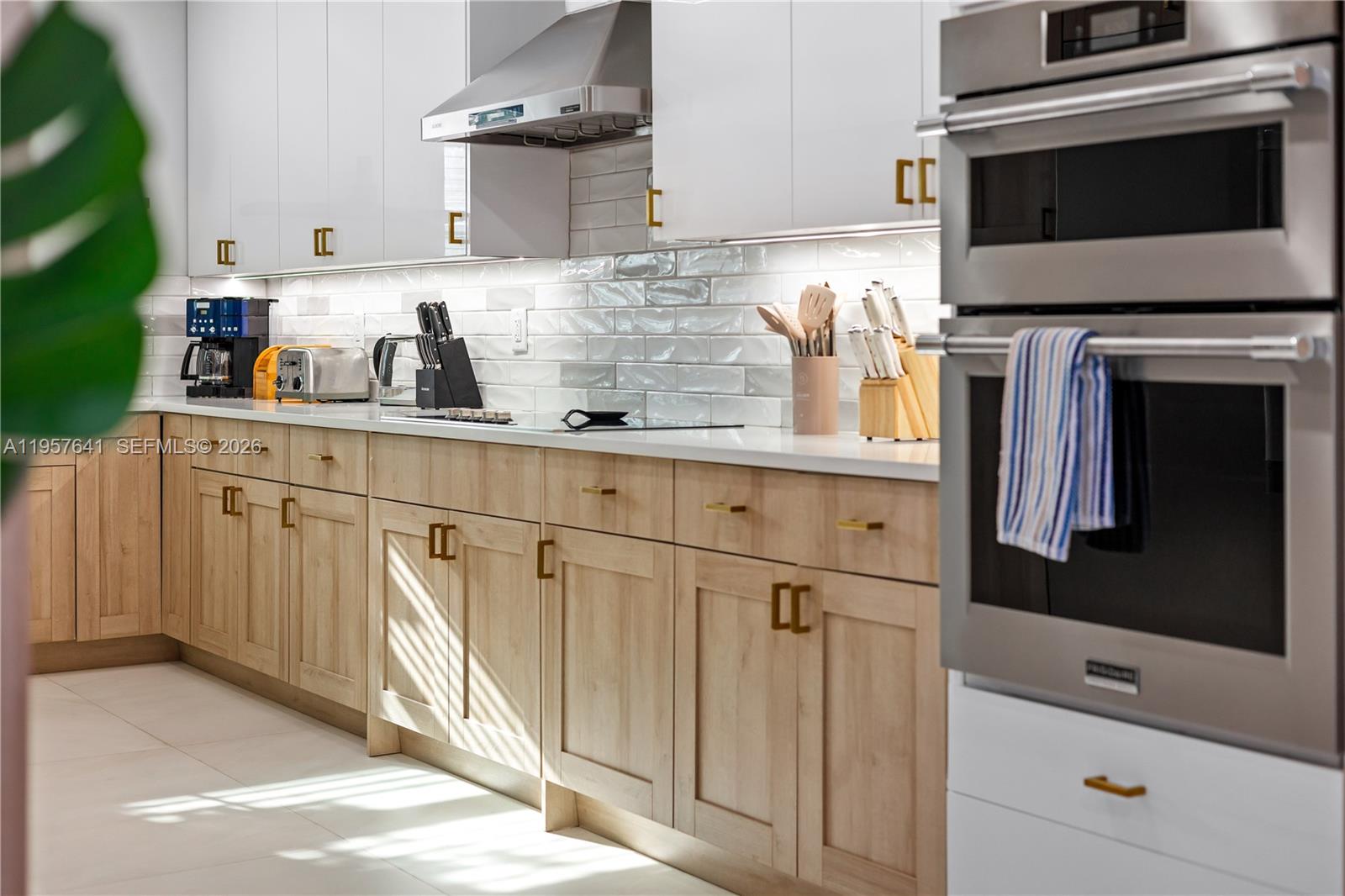 2532 Southeast 13th Street Pompano Beach, FL 33062 - Photo 44 of 69 a kitchen with stainless steel appliances white cabinets and a sink