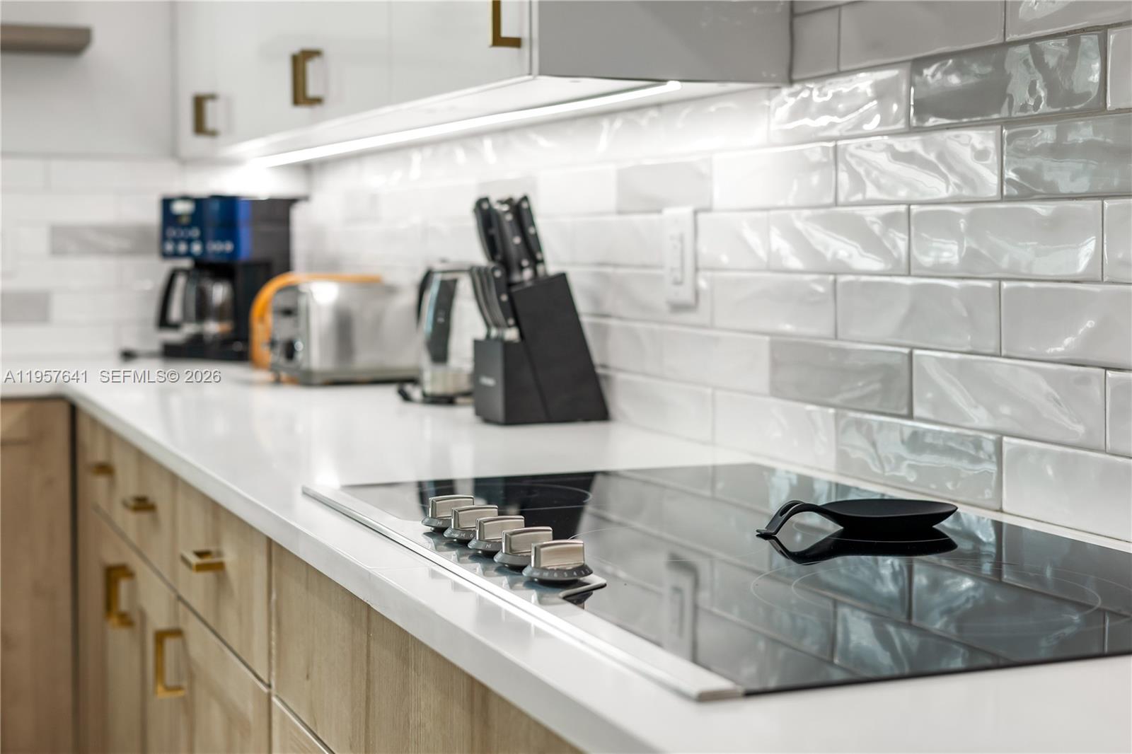 2532 Southeast 13th Street Pompano Beach, FL 33062 - Photo 46 of 69 a kitchen with kitchen island granite countertop a sink and a stove